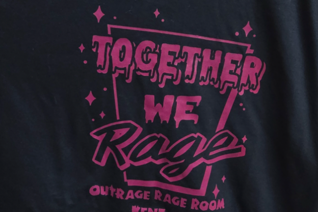 Black T-shirt with magenta text: 'Together We Rage, Outrage Rage Room, Kent, Ohio.'