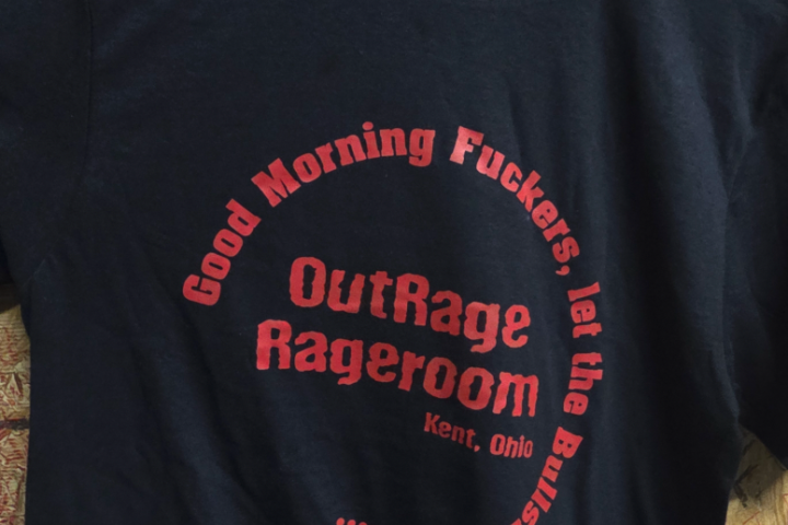Black T-shirt with red text in circular pattern.